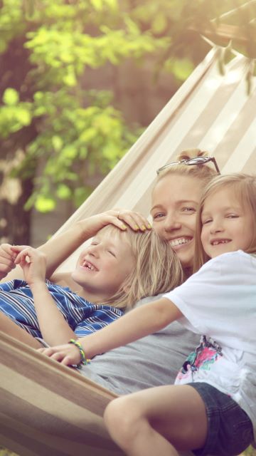 photo of a family enjoying an outdoor moment in a hammock