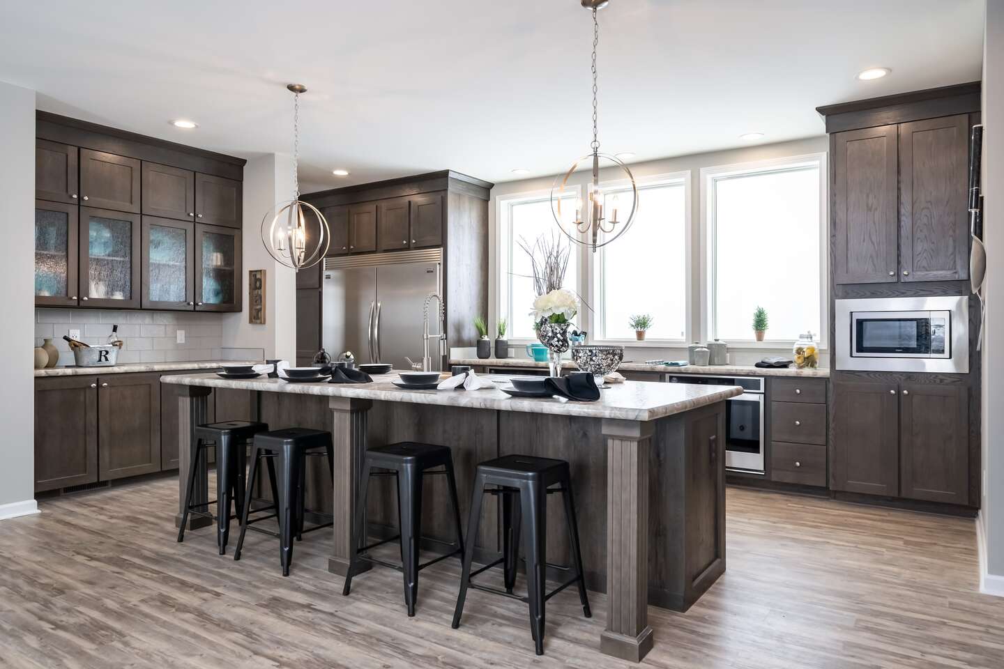 Beautiful Cavco-Crouse modular home kitchen with dark wood Evermore Custom KCMA-certified cabinets and a kitchen island big enough for the whole family to gather.